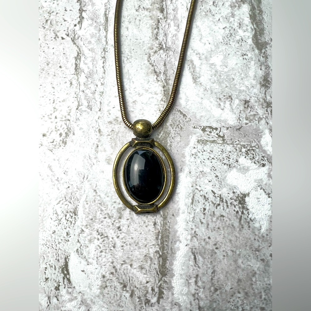 NWT Macys black and gold colored oval pendant necklace.